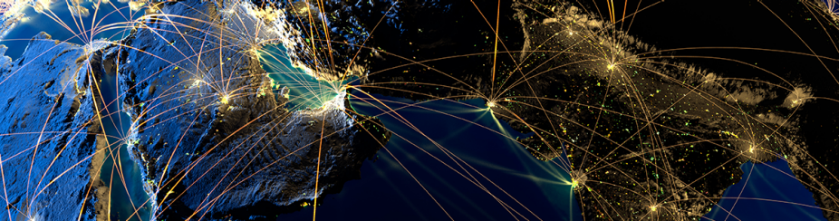Planet earth lit up with strands of light connecting different cities. 