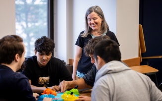 Faculty member Amy Baird leads a group of students in a class activity. 