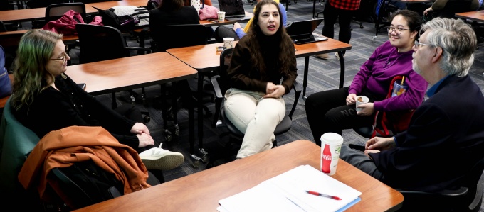 Doctoral students listen to a seminar. 