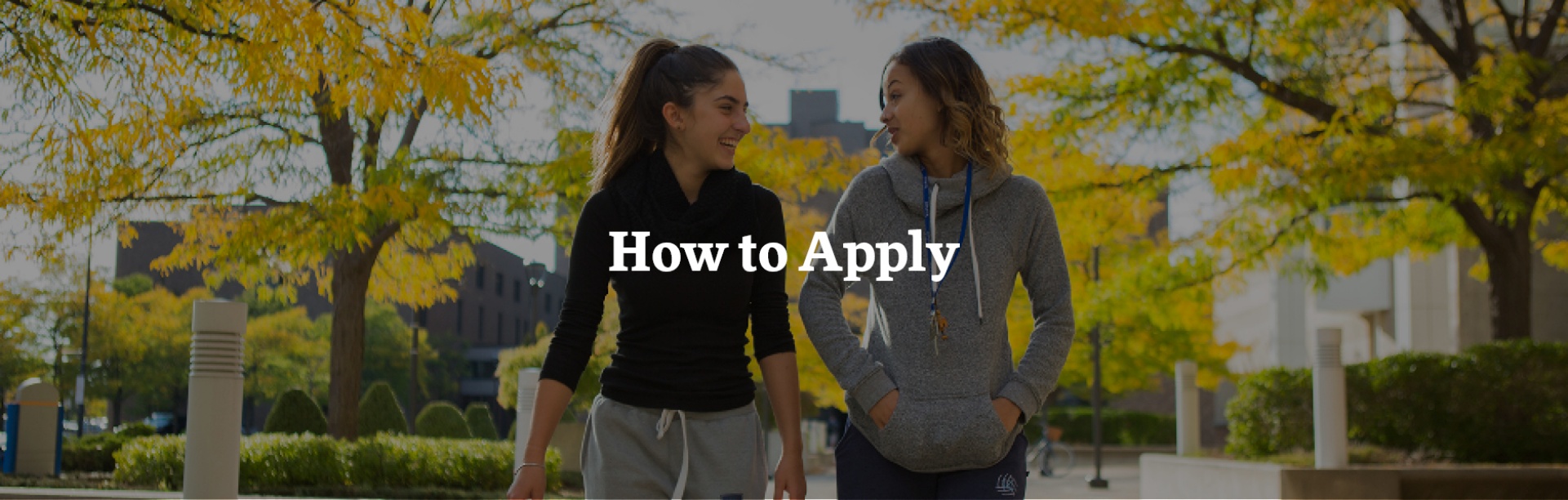 Two female students walking and talking on UB