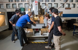 Students and machine shop staff work together in the Engineering Machine Shop. 