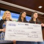 Students holding giant World's Challenge Challenge check. 