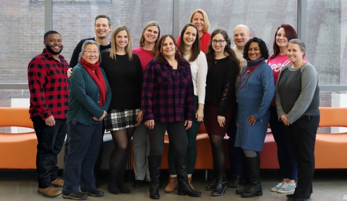 Group of staff pose together. 