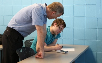 instructor helps student. 