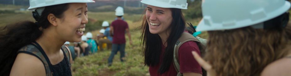 Women wearing hard hats touring a power plant. 