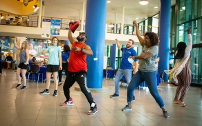 People dancing in open room. 