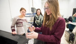 Attendees watch a demonstration during one of the day's several lab tours. 