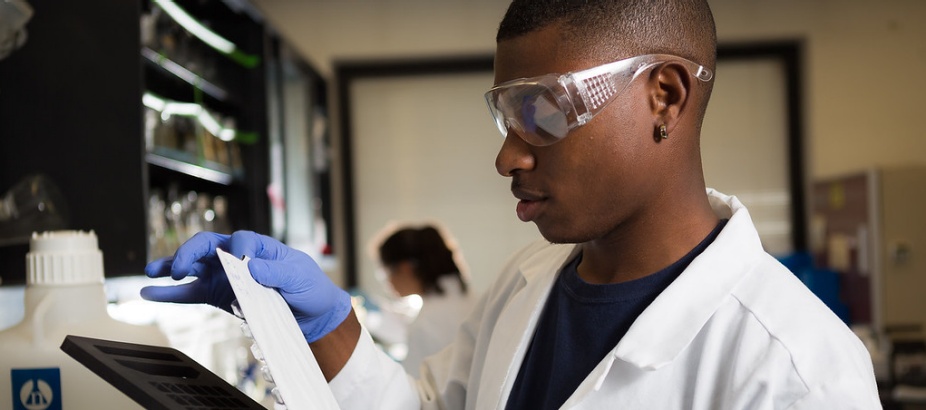 Student working in an environmental engineering lab, testing water. 