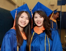 Zoom image: BS engineering degree candidates in commencement regalia (orange tassel/hood lining). 