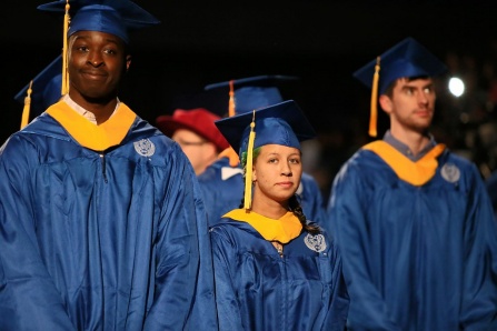 Zoom image: BS computer science degree candidates in commencement regalia (yellow tassel/hood lining). 