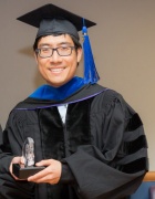 Zoom image: PhD candidate in commencement regalia. 