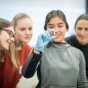 female students examining vial. 