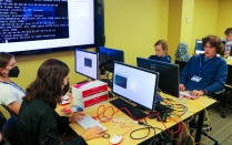Students programming on computers. 