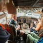 students sitting in cockpit of commercial plane. 