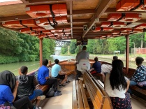 Students in boat approaching canal locks. 