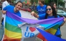 Students with rainbow flag and "I heart UB" sign. 