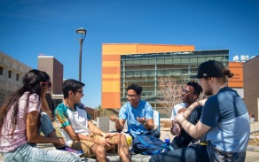 A group of students talking outside of Davis Hall at the University at Buffalo North Campus. 