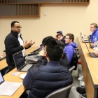 A man addressing a classroom of students. 
