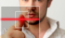 A man demonstrates a fingerprint scanner. 