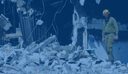 Blue-tinted image of man standing in crumbling building. 