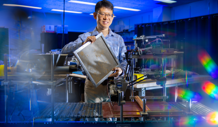 Chi Zhou holds a rectangualr wheat straw insulation. 