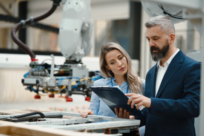 Two people reviewing a document in a lab. 