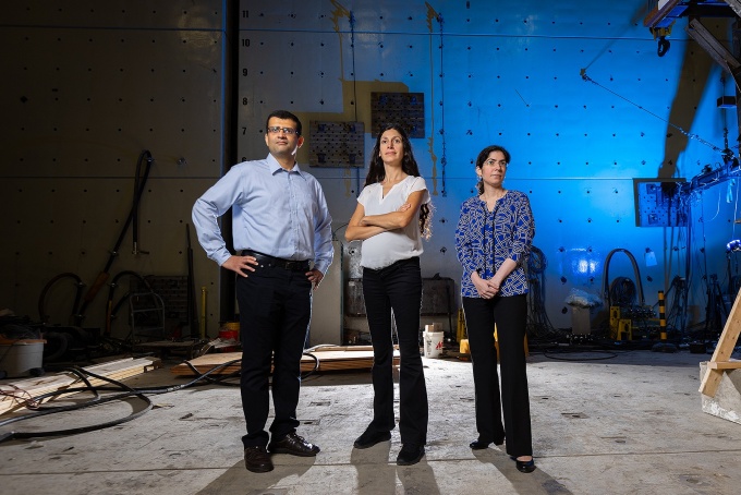 A portrait of Ravi Ranade (left), Pinar Okumus (center), and Negar Elhami-Khorasani (right), all faculty members in the department of civil, structural and environmental engineering, photographed in Ketter Hall in September 2023. 
