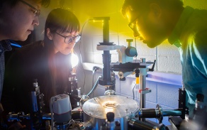 Lab of Jung-Hun Seo as he works with two students looking over a project. 