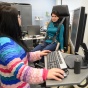 two female students working on workplace safety research in an ISE lab. 