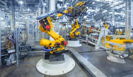 robotic arm on a production line in a car manufacturing facility. 