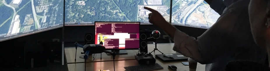 Faculty member views a map on the screen in the optimator lab. 