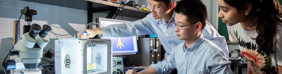 Chi Zhou and students in manufacturing lab. 