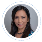 Head shot of Cecilia Martinez Leon, a Latino woman with black hair wearing a blue and white polka dot dress. 