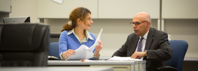 photo of Dr. Batta meeting with a graduate student. 