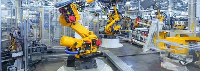 robotic arm on a production line in a car manufacturing facility. 
