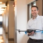 ISE faculty member holding a drone. 