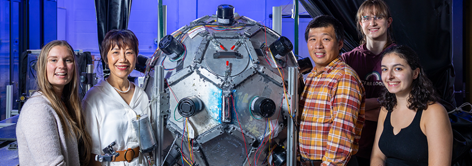 Danielle R. Johnson, Hui Meng, James Chen, Adam Bocanski and Emily M. Diorio pose around the turbulence chamber the researchers used for experiments.