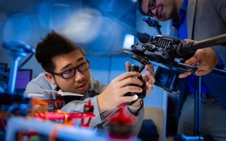 Students work on drones and other unmanned vehicles in the lab of Souma Chowdhury.