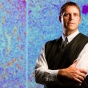 shot of Joseph Balthasar with image of cell in the background. 